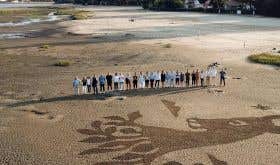 Osmin crew standing on the beach