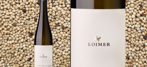 Loimer Loisenberg Grune Veltliner bottle against a background of white peppercorns