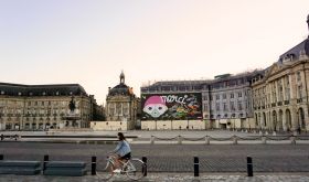 A woman bikes near Bordeaux's deserted Place de la Bourse during France’s first Covid-19 lockdown. Photo author's own