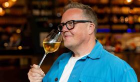 Olly Smith sniffing a glass of white wine