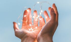 person holding string of lights