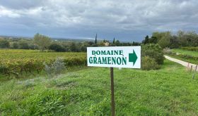 Domaine Gramenon sign with vineyards behind