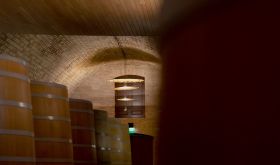 Barrels under the vaulted ceiling of Vega Sicilia's cellar