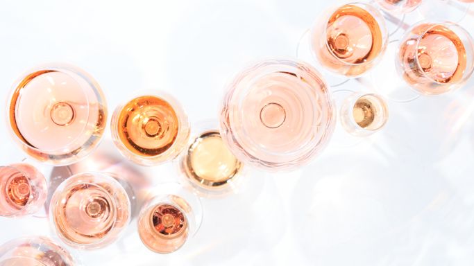 Many glasses of rose wine at wine tasting, seen from overhead