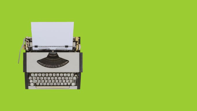 typewriter on chartreuse background. Image by Constantine Johnny via Getty Images.