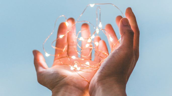 person holding string of lights