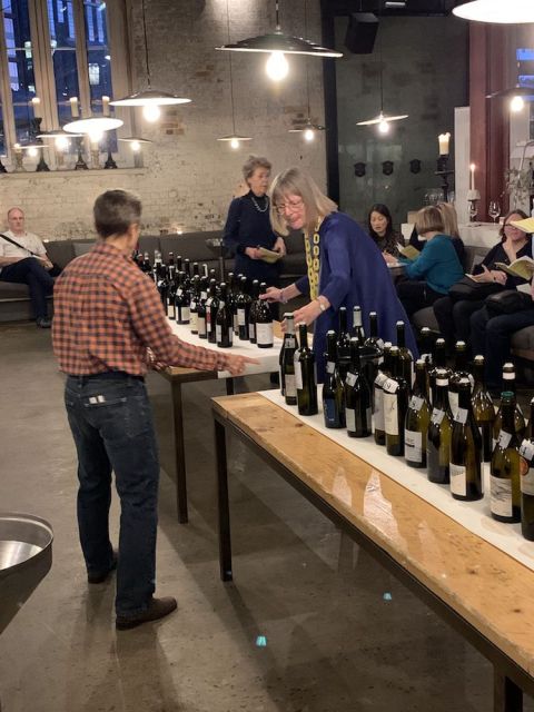 Julia and Jancis put out bottles for Greek Wine Night