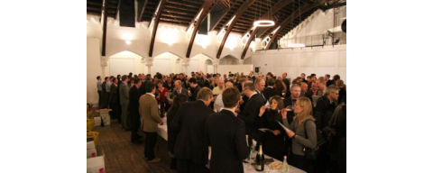 A crowd of people tasting champagne at the Jancis Robinson dot com ten year anniversary