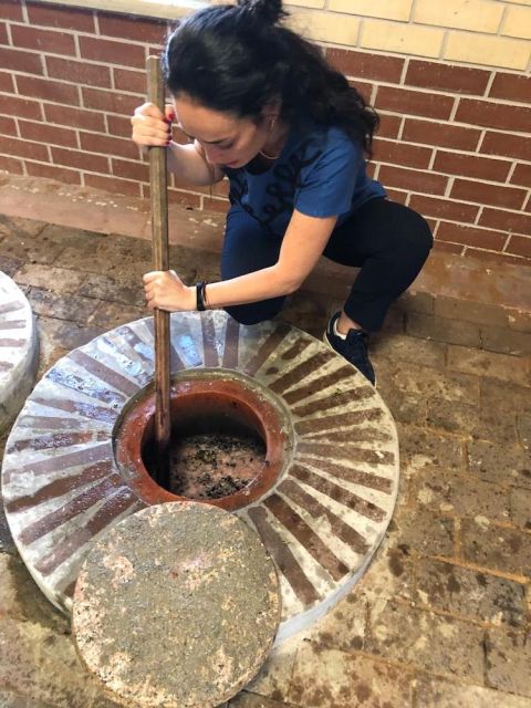 Safiye Arifagaoglu of Meshashuna punching down her Rkatsiteli-filled qvevri, courtesy of Safiye Arifagaoglu