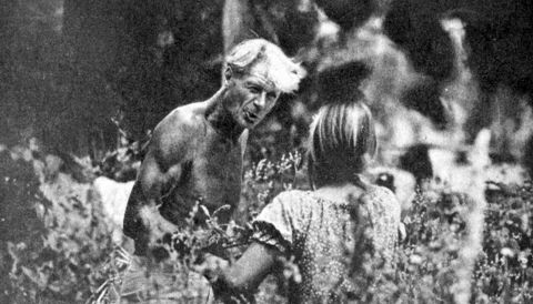 A shirtless Alan Chadwick talks to a female apprentice in the teaching garden at Covelo in 1976; photo by Sandy Solomon