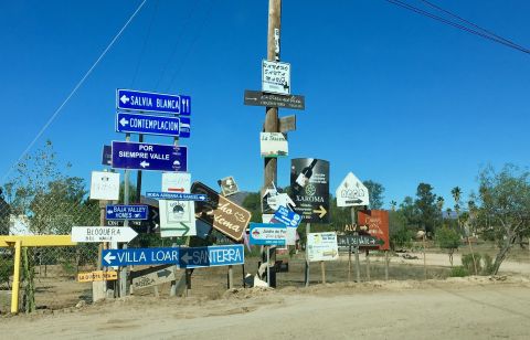 A crowded corner of winery and restaurant signs points to the rampant development in Baja, Mexico