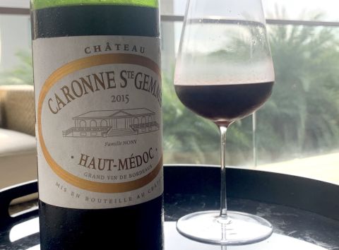Bottle of Caronne Ste Gemme 2015 with glass