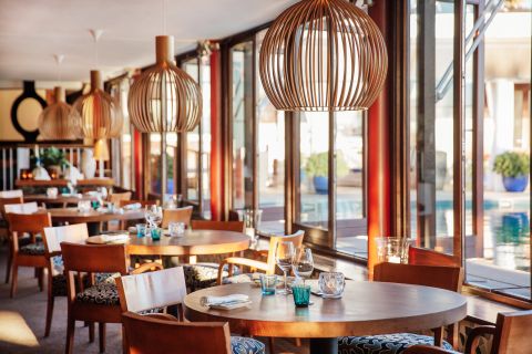 The dining room looks out on the pool