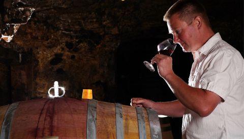 Stéphane Guion tasting wine in his cellar.