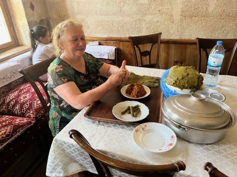Stuffing vine leaves at The Old Greek House