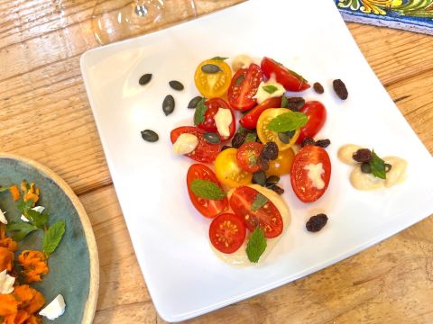 Tomato, tahini, pumpkin seed and raisin salad