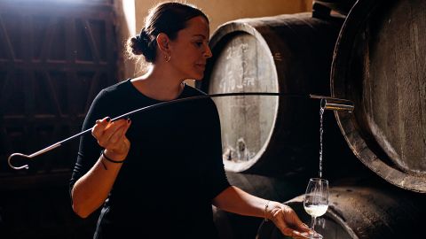 Silvia Flores sampling sherry from a cask
